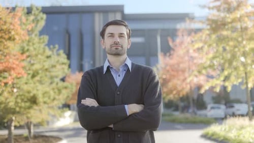 Confident Man Standing Outdoors on a Sunny Day