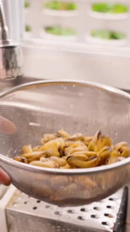 Steamed Mussels Shaken in a Colander in Kitchen