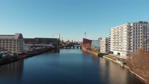 Berlin wall from the river Spree with a drone flying along the river and showing the Berlin TV anten