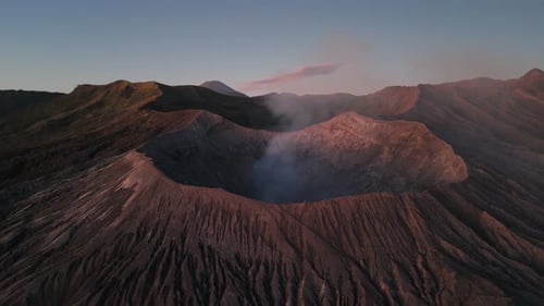 Aerial View of Mount Bromo Volcanic Crater Emitting Smoke At Sunrise. Bromo Tengger Semeru National