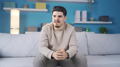 Emotional and depressed young man is crying.