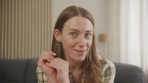 Woman Talking to Camera While Sitting on Couch