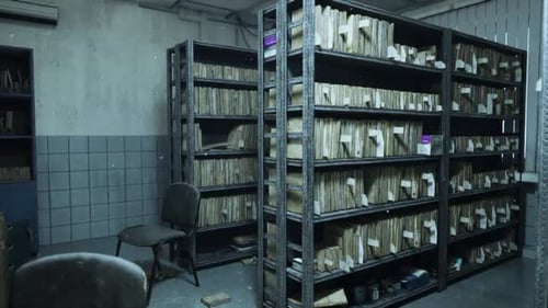 Abandoned Hospital Archives Showing Deteriorating Shelves and Dusty Records