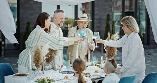 Happy Family and Friends Celebrate Together Outdoors