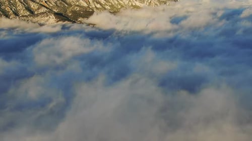 Aerial View of Mountains Over Clouds