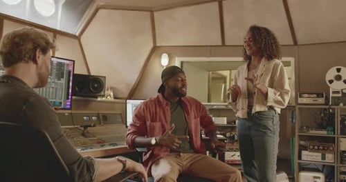 Band Composing with Producer in Music Recording Studio