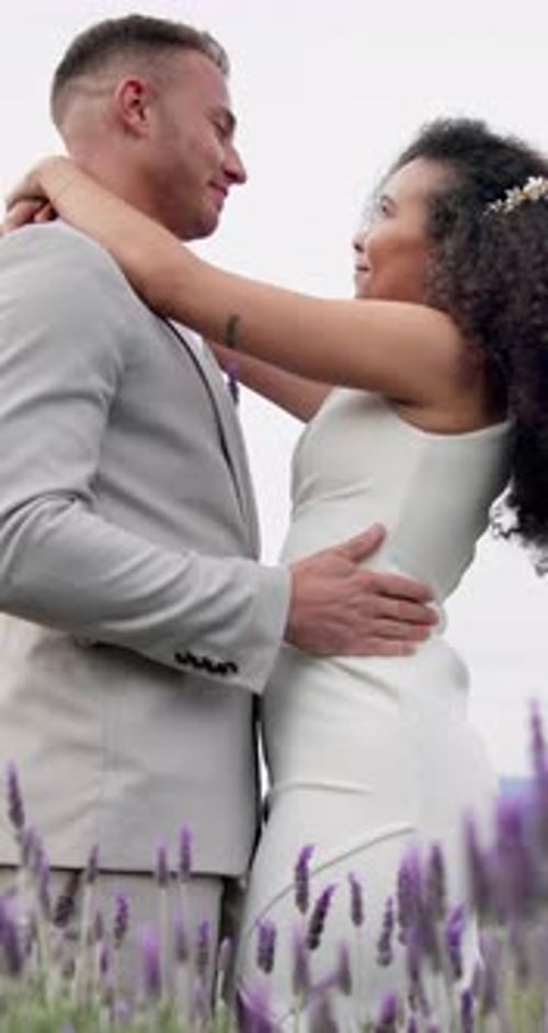 Loving Couple Embraces in Lavender Field on Wedding Day