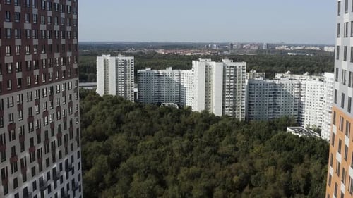 Panning View of Residential Buildings Near Green Forest