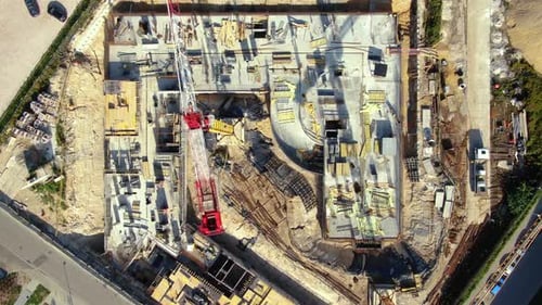 Aerial Flight Over a New Constructions Development Site with High Tower Cranes Building Real Estate.