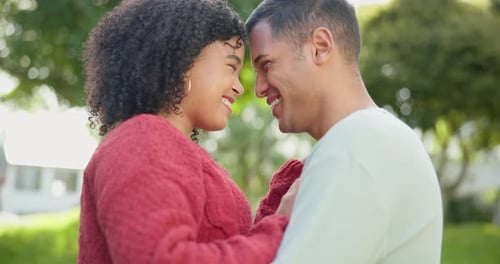 Close Up of Smiling Couple Touching Foreheads Outdoors