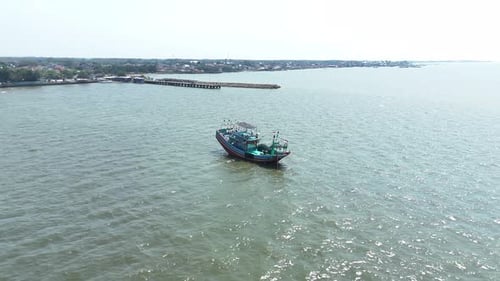 Aerial View Captures Tranquil Scene of a Boat on Sparkling Sea