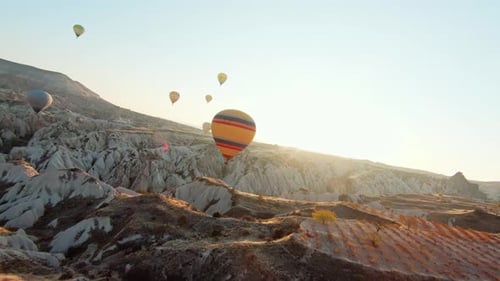 Hot Air Balloons Over Cappadocia Landscape At Sunrise In Turkey. - aerial FPV