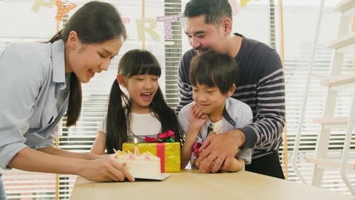 Happy Family Celebrating Birthday with Cake and Presents