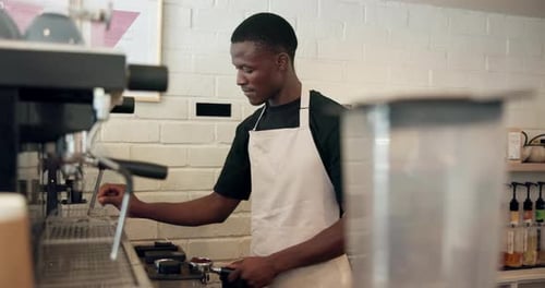 Young Adult Preparing Coffee in Cafe Workplace