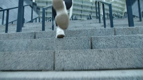 Closeup Female Legs Running Up Stairs In Slow Motion. Close Up Fitness Girl Climbing Upstairs. Ba...