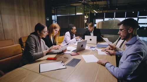 A Collaborative Team Meeting Takes Place in a Modern Office Environment Fostering an Atmosphere of