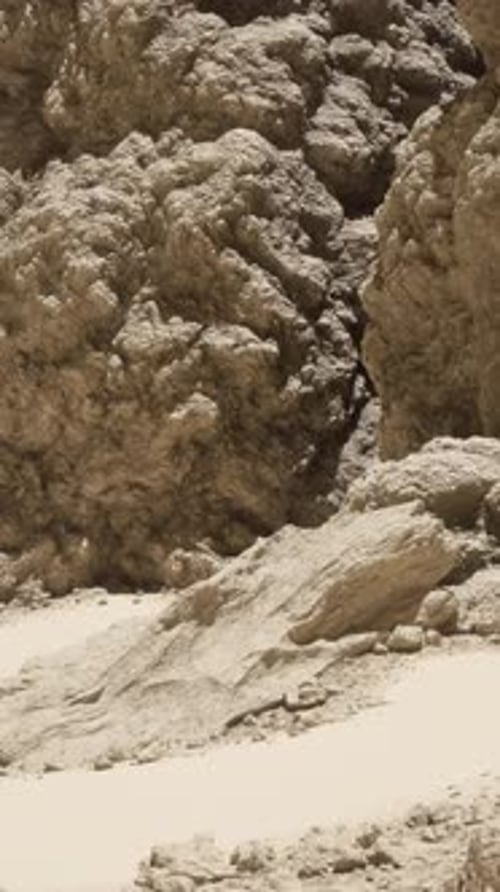 A Group of Large Rocks Sitting on Top of a Sandy Beach
