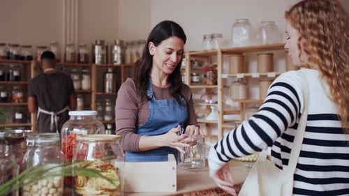 Young Woman Buying Fresh Pasta in Zero Waste Shop