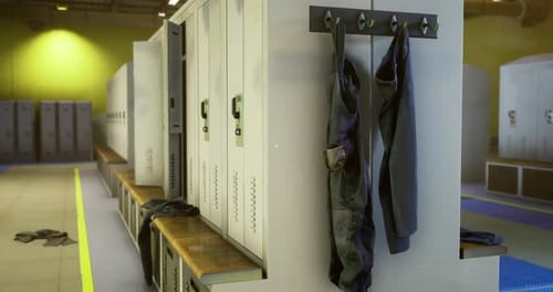 Locker Room with Open Lockers and Sports Gear Hanging at a Training Facility
