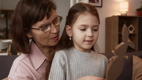 Grandmother and Granddaughters Crafting Wooden Easter Bunny Together