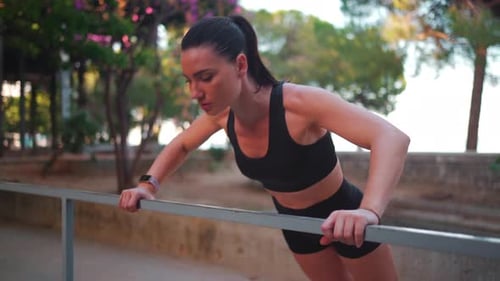 Athletic Woman Doing Push-Ups in Outdoor Park