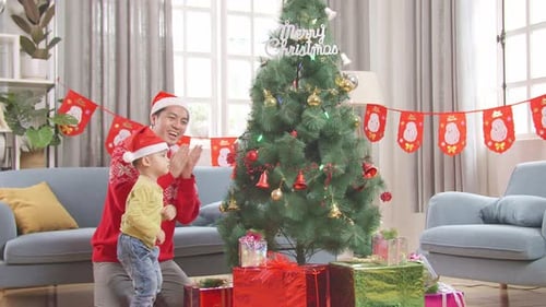 Dad and Child Decorating Christmas Tree Together