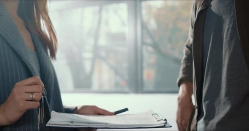 Closeup Hand of Client Man Taking New Apartment Keys From Real Estate Agent Woman