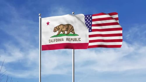 Waving California and USA Flags Against a Blue Sky