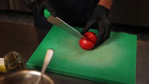 Chef Slicing a Tomato into Wedges
