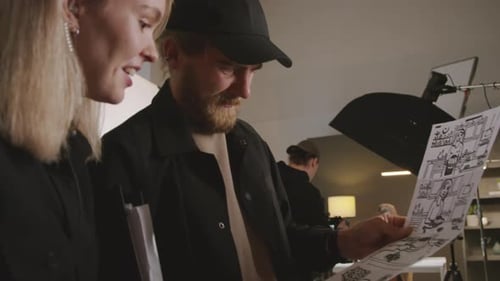 Crew looks at storyboard in filming studio