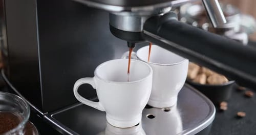 Home Espresso Making Process Coffee Stream Pouring From Machine Into Ceramic Cup