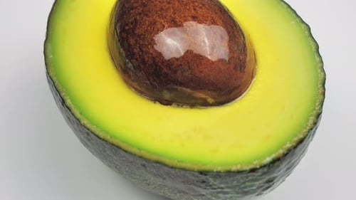 Closeup of One Half Cut Avocado is Rotating on the Turntable