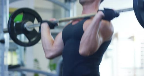 Guy bodybuilder in the gym, works with a barbell, bench press, improving triceps, large pectorals