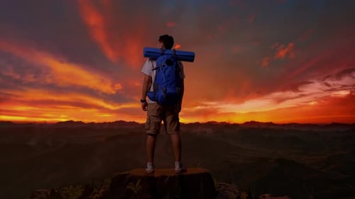 Male Looking Around On Top Mountain