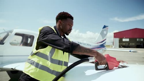 Black Ground Technician Refueling Wing Talk of Small Aircraft