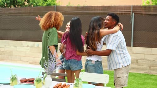 Happy Friends Hugging and Celebrating at Garden Party