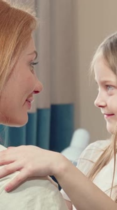 Loving Mother and Daughter Hugging Indoors
