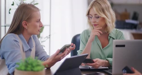 Women Discussing Business at Office Table