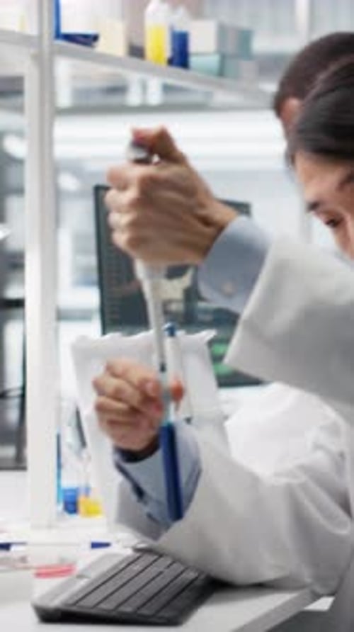 Scientist Mixes Liquid in Laboratory Test Tube