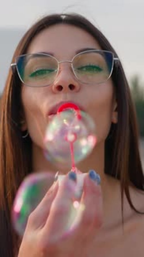 Portrait Happy Brunette Woman Wearing Glasses Blowing Soap Bubbles