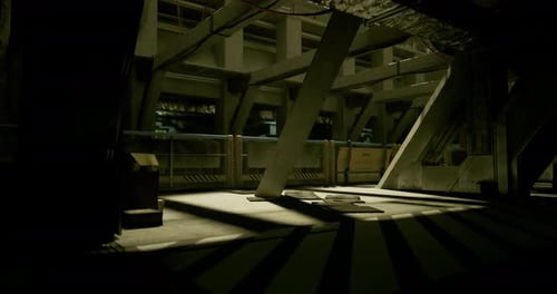 Shadows Dance Across the Industrial Space Illuminated By Low Light