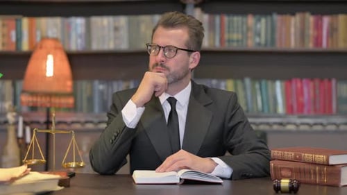 Pensive Middle Aged Lawyer Reading Book in Office