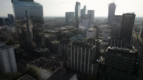 Aerial establishing orbit over the downtown of a modern capital city with glass facades of skyscrape