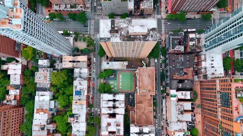 Tops of the high and low buildings and busy streets. Drone flight over the panorama of New York, USA