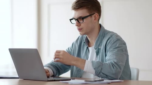 Thoughtful Guy Working on Laptop at Home Office