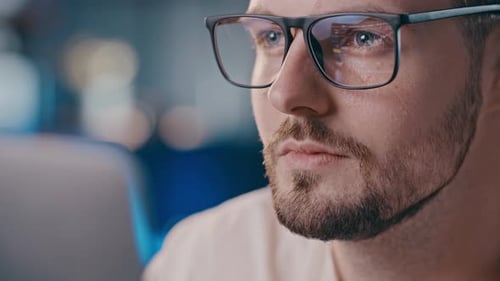Man Focused with Computer Reflection in Glasses Close Up
