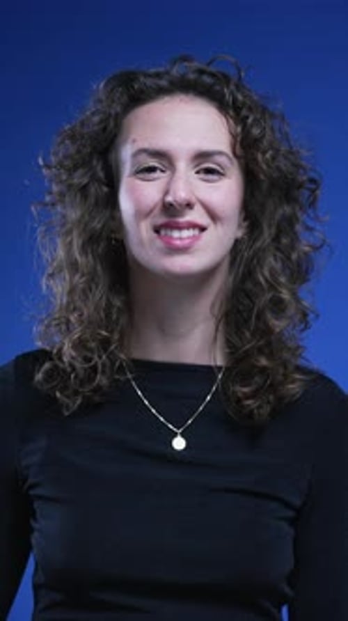 Smiling Woman Waving Hello on Blue Background