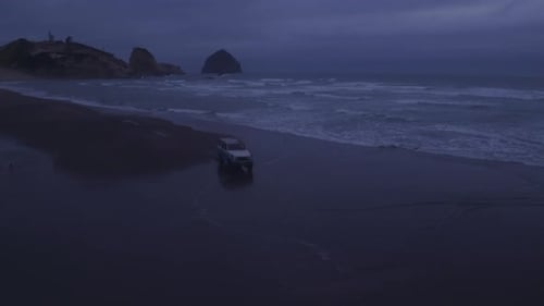 Aerial View of Group of Friends Driving on Beach in Vintage Vehicle Aerial