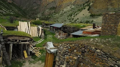 Captivating Drone Footage of Historic Stone Building in a Scenic Gorge