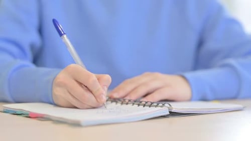 Close up of Woman Writing Letter in Office